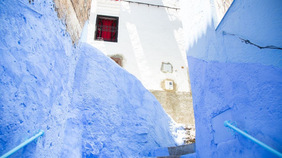 Blue painted stairs between blue walls in Chefchaouen