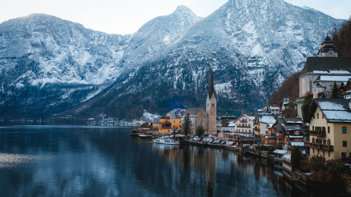 Hallstatt in winter below snowy mountains