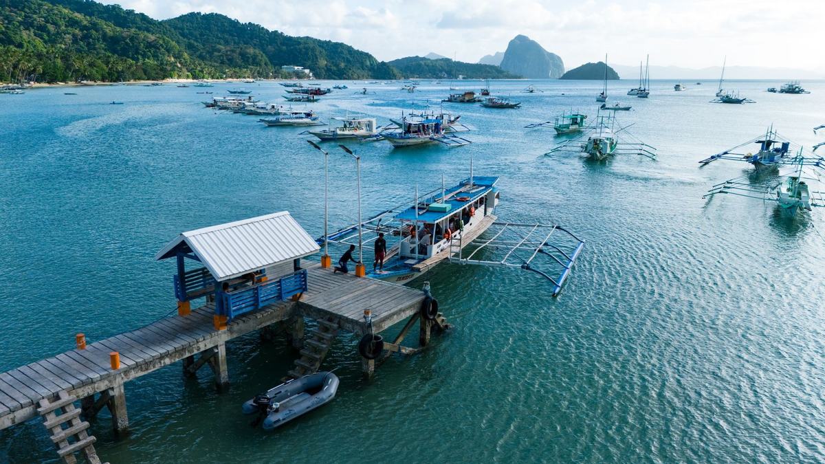 Traditional bangka boats at a wooden pier in El Nido