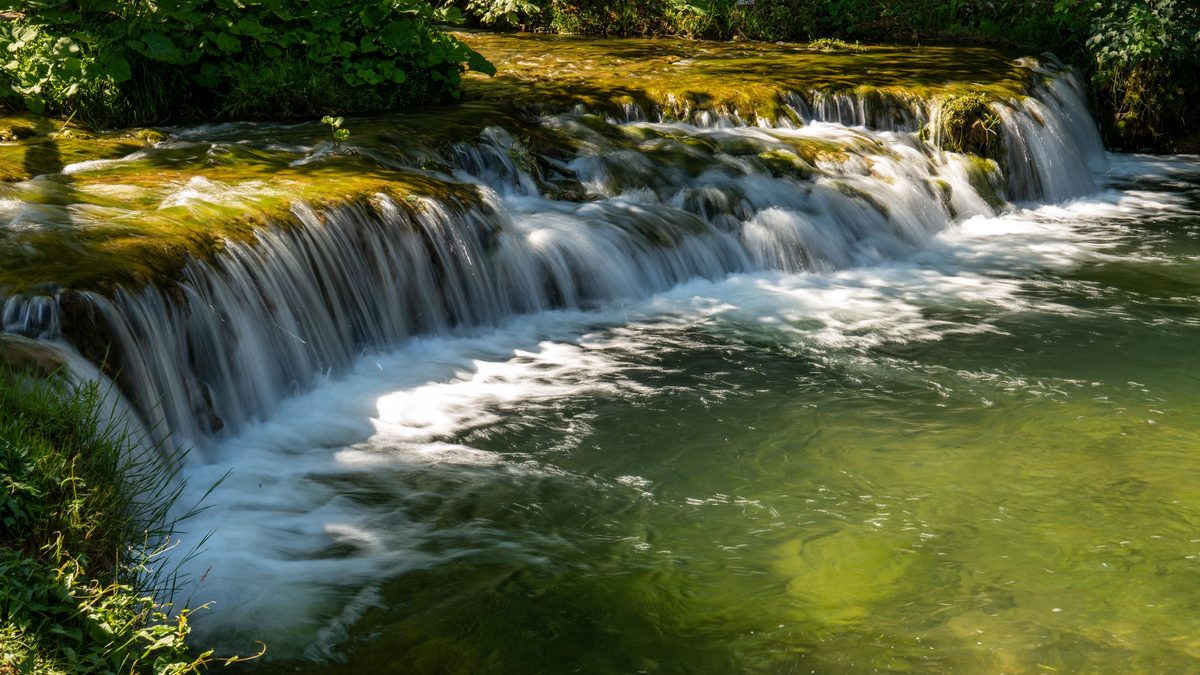 Rastoke village and its waterfalls in warm evening light