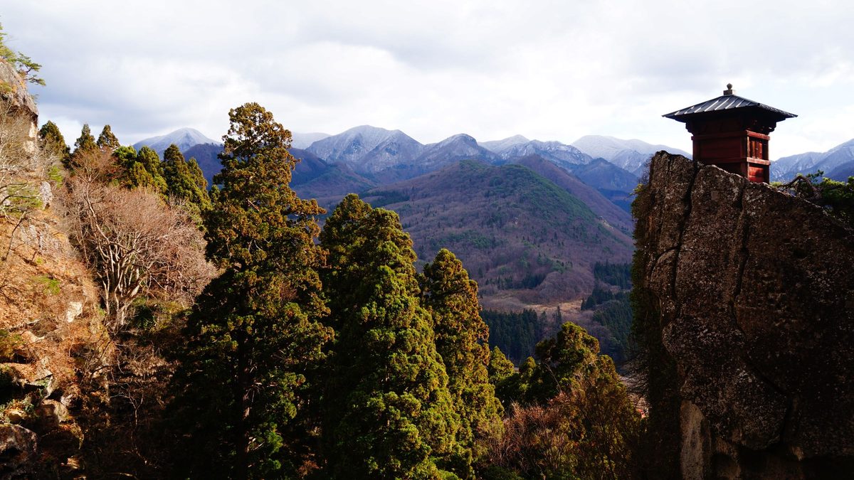 A small red hall on a rock above the mountain valley at Yamadera